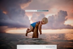 North American spine hands holding baby above water