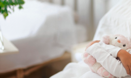 child holding stuffed animal