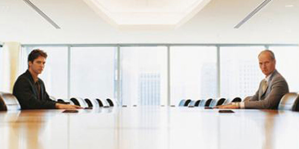 two men at conference room table