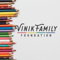 Vinik family foundation logo next to assortment of colored pencils