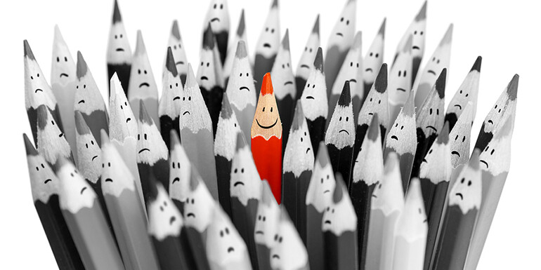 red pencil in field of grey pencils
