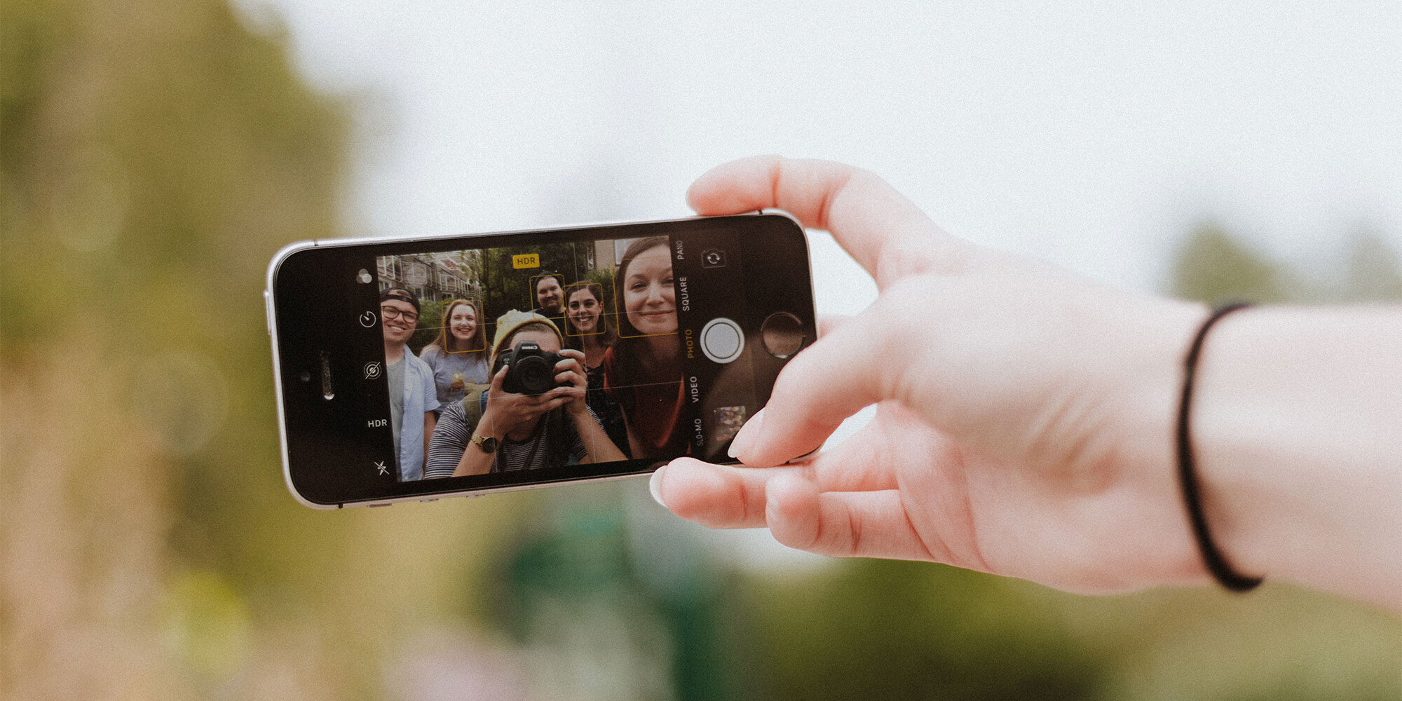 hand taking a selfie of a family