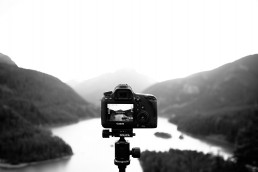 camera on tripod over mountains