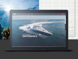 the intrepid difference photo on laptop screen of boat driving on water