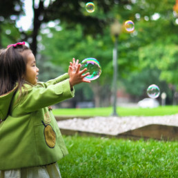 Girl catching bubbles with her hands