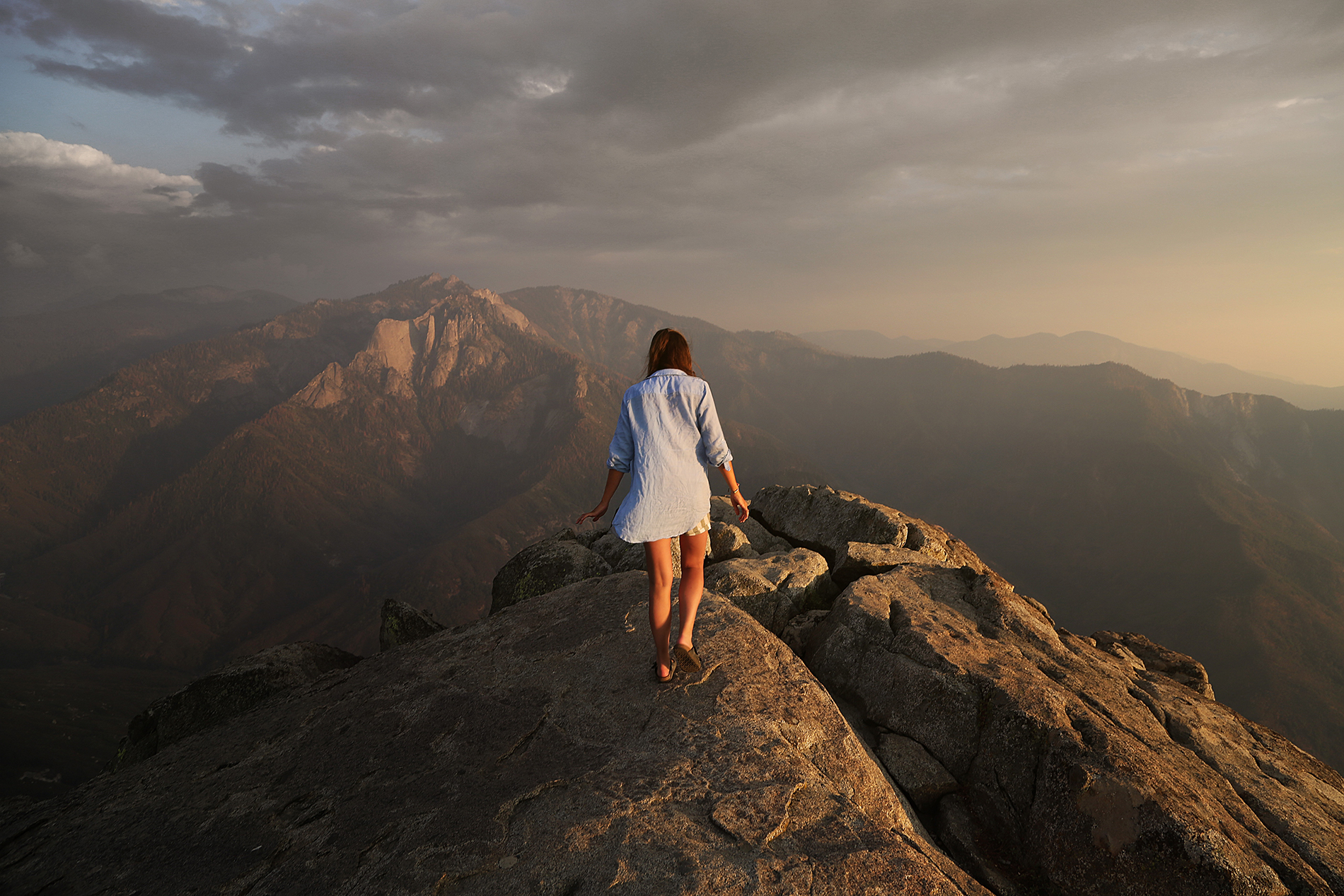 woman walking on top of mountain