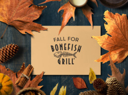 Fall for bonefish flat lay with autumn leaves and pinecones