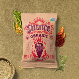 solstice organic tortilla chips with corn and other ingredients slayed out on table